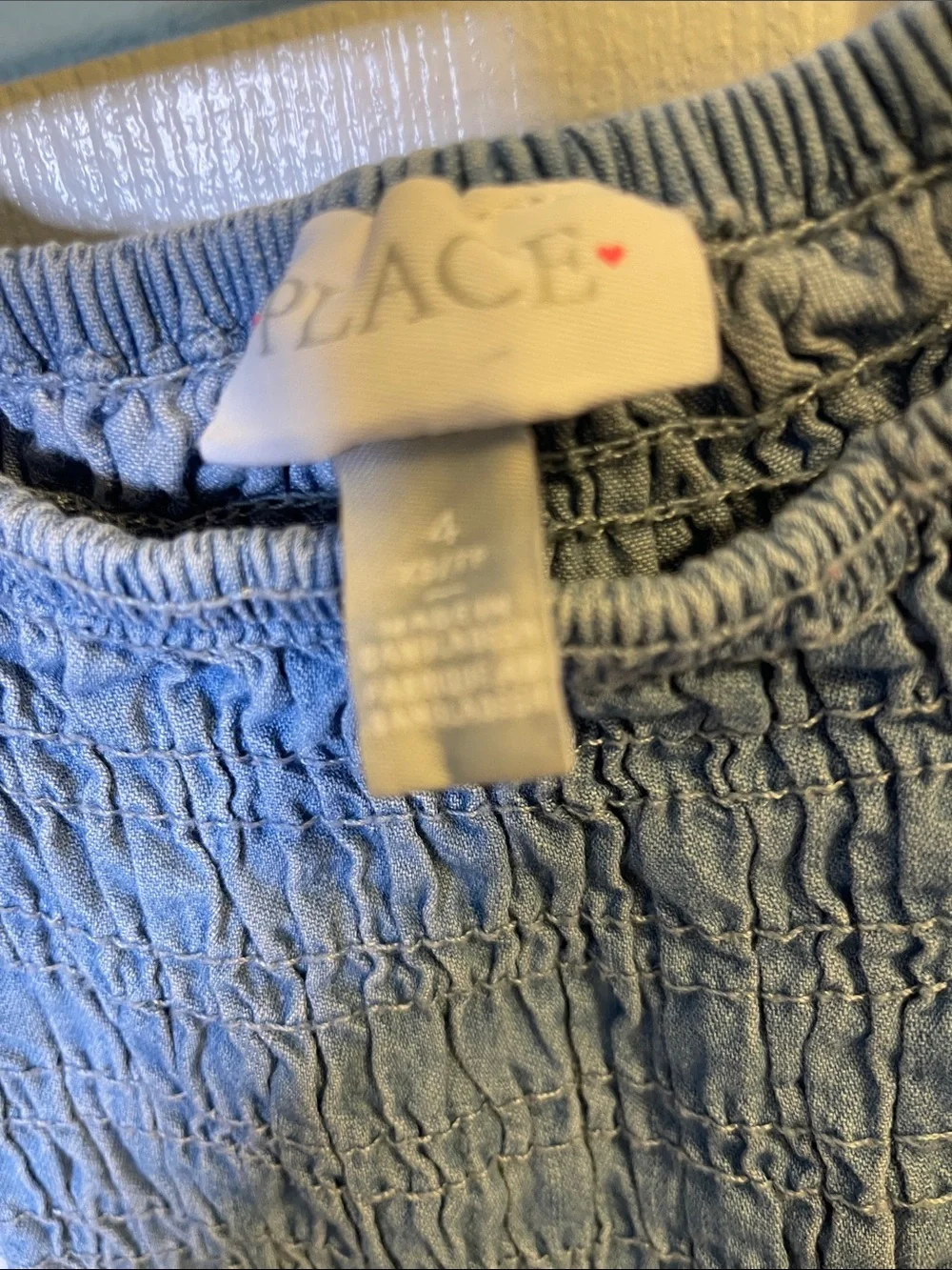A Children’s Place.” Girls' Light Blue Chambray Smocked Dress - Picture 4 of 4